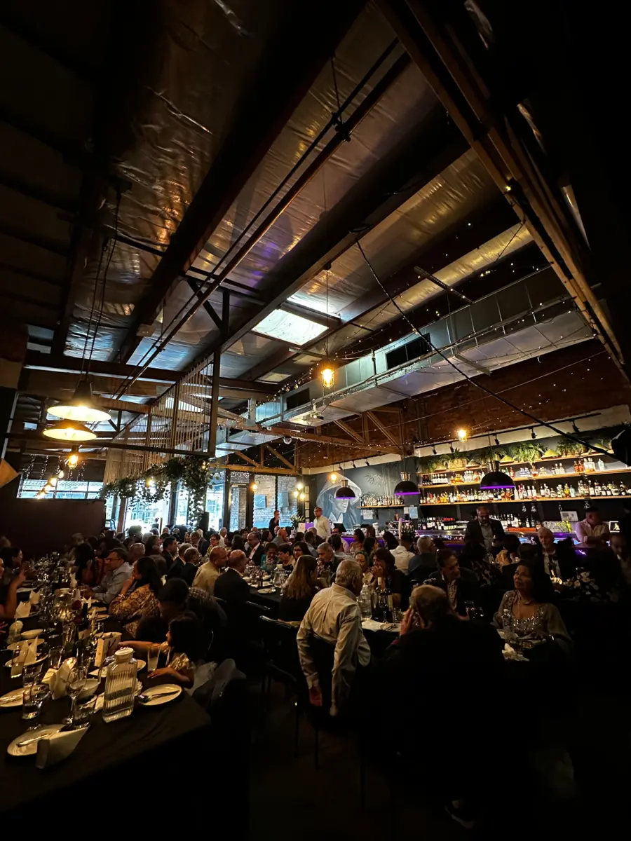 Mister Minh's dining room set for a large function, with the bar and Vietnamese mural at the back